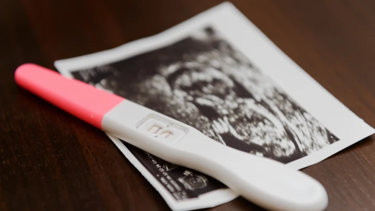 Pregnancy test and ultrasound photograph
