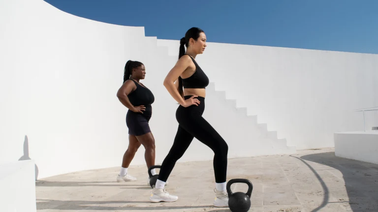 Two women running outdoors after sports injury rehabilitation