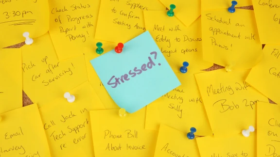 Sticky note reading 'Stressed?' pinned to a board