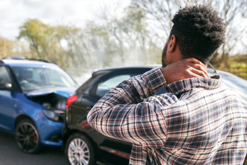Man holding his neck in pain after a vehicle accident
